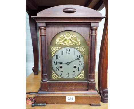 A reproduction bracket clock with brass and silver dial with striking movement 