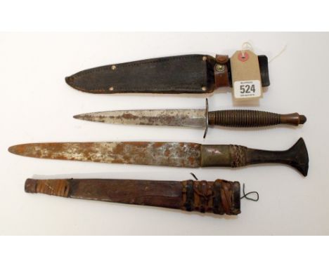 Army commando dagger with metal grip in its leather scabbard, blade length 17cm, together with a North African dagger with le