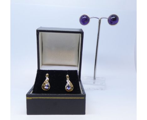 Pair of amethyst cabochon earrings in 9ct gold and a pair of drop earrings set with tanzanite