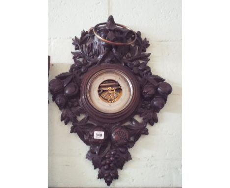 A Victorian Black Forrest style carved oak framed wall barometer decorated with lion mask and fruit 