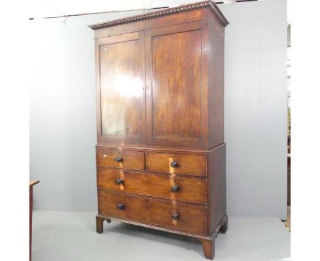 A 19th century mahogany two-section linen press, with two panelled doors above two short and three long drawers. 132x224x64cm