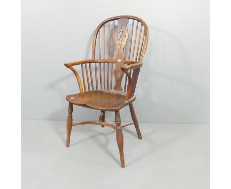 A 19th century elm-seated comb back Windsor elbow chair with crinoline stretcher. Overall 52x102x55cm, seat 38x44x40cm.