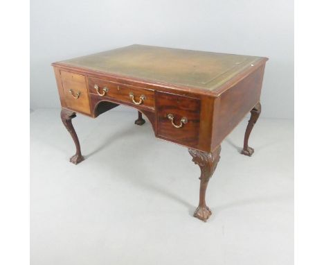 An antique mahogany Chippendale style partner's writing desk, with tooled and embossed green leather skiver, seven drawers an