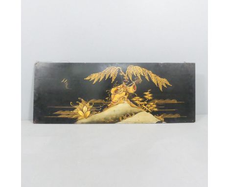 An Oriental lacquered panel with gilded decoration. 102x38cm.