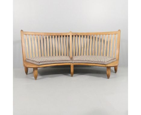 Guillerme et Chambron, France, a 1960s curved oak bench sofa, length 198cm, depth approx 86cm, seat height 26cm Wear and repa