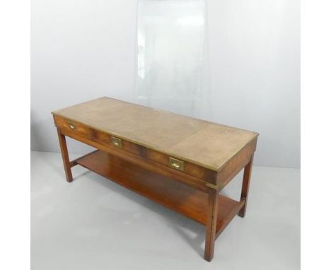 A campaign style mahogany and brass mounted campaign style two-tier coffee table, with inset tooled and embossed leather pane