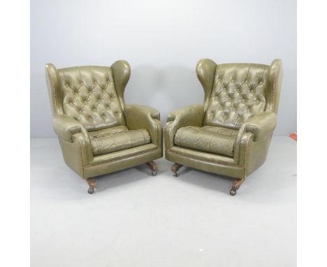 A pair of Green button-back leather upholstered reclining wing armchairs, with studded decoration. Overall 90x100x85cm, seat 