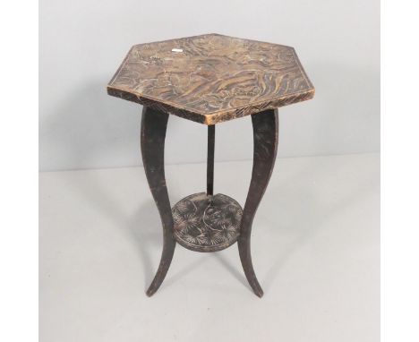 A Japanese lacquered two-tier hexagonal occasional table, with carved three wise monkeys decoration and raised on tripod base