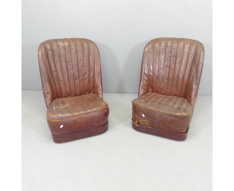 A pair of vintage red leather-upholstered car seats. Overall 56x70x75cm.
