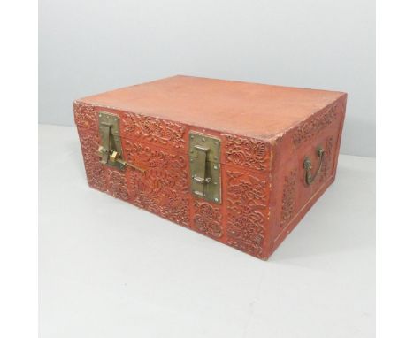 A large red painted Japanese leather storage trunk, with oversized carry handles and brass locks. 92x40x66cm.