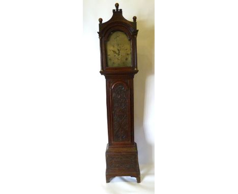 A George III Oak Longcase Clock the arched hood with reeded pilasters and three brass finials above an arched carved door and