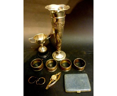 A London Silver Spill Vase of Embossed Form together with four silver napkin rings and a small silver two handled trophy cup,