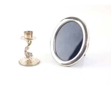 Sterling silver cast candlestick holder with body in the form of a sea serpent, and a silver framed photo frameCondition Repo