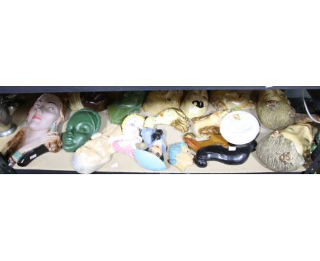 Collection of 17 plaster and ceramic 1930/1940 and later wall masks together with a plaster figure of a young girl 60cm