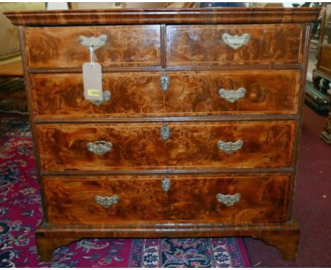 An 18th century veneered figured walnut chest of two short over three long drawers, raised on bracket feet, H.91 W.97 D.54cm 