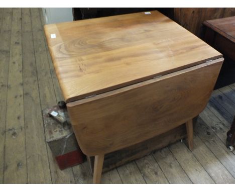 A light Ercol flap leaf kitchen table