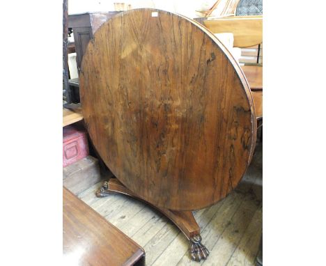 An early Victorian circular rosewood tilt top table on tripod base with ball and claw feet, diameter 53"