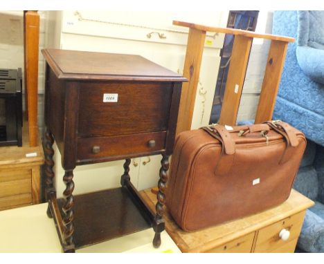 An oak sewing box on barley twist leg stand, pine hanging shelves, a dining chair and a vintage suitcase
