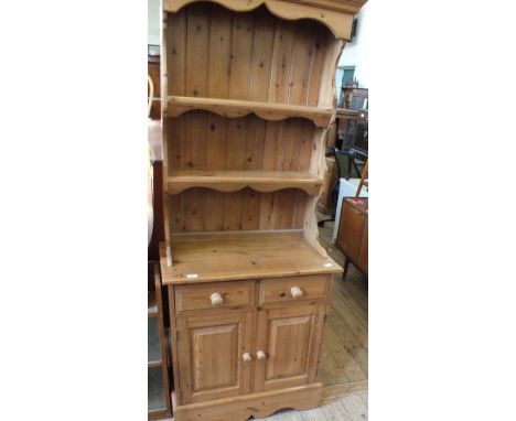 A modern narrow pine shelf back dresser with two drawers over a two door cupboard base