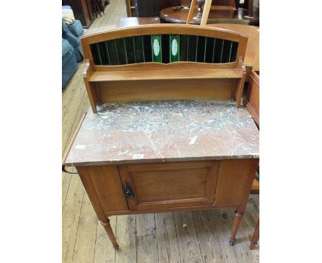 An Edwardian rouge marble top washstand with towel rail and tiled shelf back