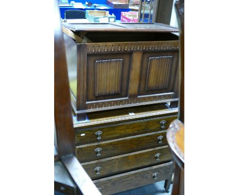 Reproduction dark oak panelled linenfold blanket chest with a 20th oak chest of 4 drawers on casters and a Windsor and Newton