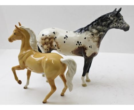 TWO ROYAL DOULTON CERAMIC EQUESTRIAN FIGURES; Palomino horse, 18cm and an Appaloosa horse, 21cm (2) 