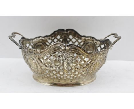 A CONTINENTAL SILVER SWEETMEAT BASKET having pierced lattice form with repousse swag and portrait head decoration, fitted two