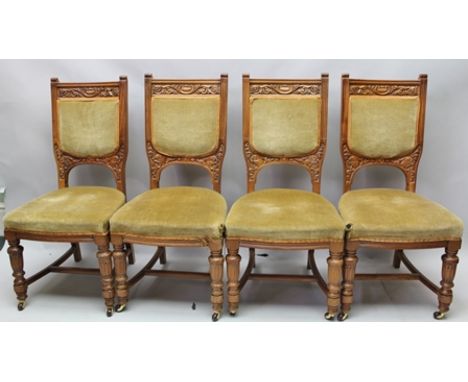 A SET OF FOUR LATE VICTORIAN/EDWARDIAN WALNUT FRAMED SINGLE DINING CHAIRS with carved decoration, upholstered seat and back p