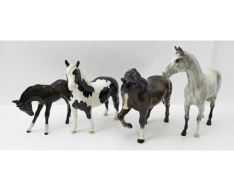 FOUR BESWICK CERAMIC EQUESTRIAN FIGURES; Piebald mare 17cm, Grey mare 20cm and Bay mare and Foal, 16cm and 11cm (4) 