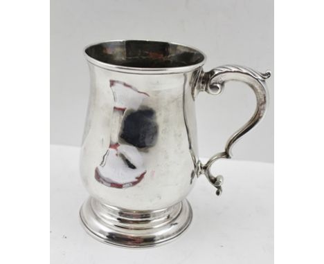 WILLIAM AND JAMES PRIEST A GEORGE III SILVER TANKARD of plain baluster form, the handle with acanthus leaf thumb piece, Londo