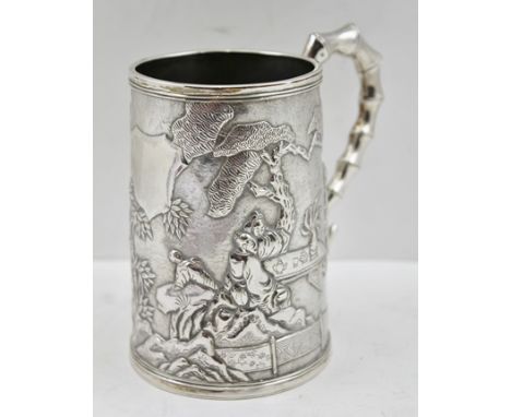 A CHINESE SILVER TANKARD with cast bamboo effect handle, the slightly tapering body with figures in landscape decoration in t