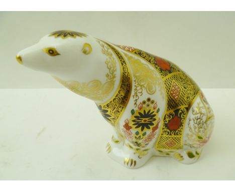 A ROYAL CROWN DERBY BONE CHINA PAPERWEIGHT, "Polar Bear", decorated and gilded in the Imari palette, with gold button, 11cm h