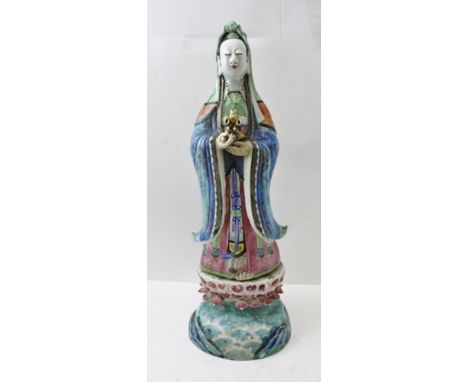 A 19TH CENTURY CHINESE PORCELAIN GUANYIN STATUE, polychrome painted, standing upon lotus and water painted base, 46cm high 