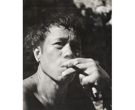 * Philippines. Close-up head portrait of a smoking Filipino, by Pierre Verger, circa 1940, gelatin silver print, small crease