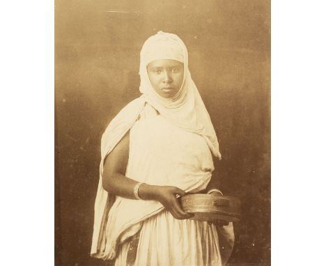 * North Africa. A portrait of a young North African woman holding a tambourine, c. 1880s, albumen print on thin card mount, 2