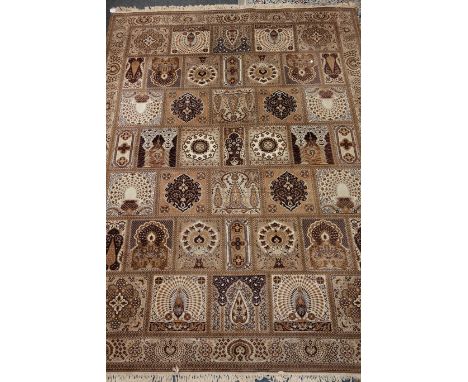 Keshan Super carpet, decorated with assorted panels and floral borders, in beige and browns 296cm x 400cm Condition Report Cl