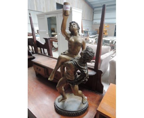 A reproduction lamp base modelled as lovers
