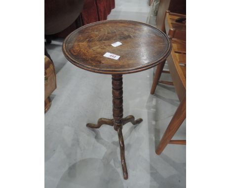 An early 20th century oak pedestal wine table