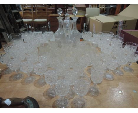 A selection of crystal wine and spirit glasses, etched decanters etc