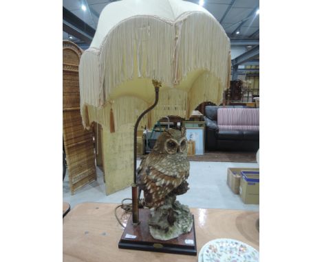 A brass stemmed table lamp on treen base with ceramic owl study by Guiseppe Armarni