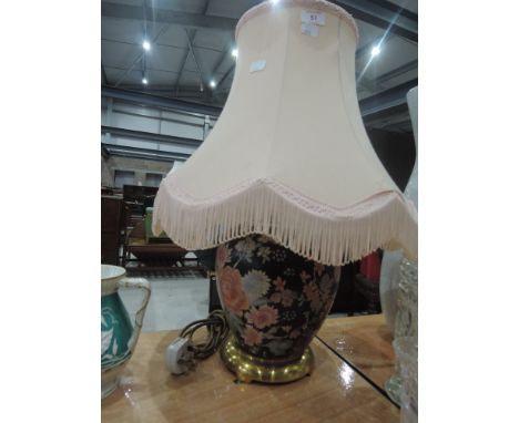 A ceramic table lamp and shade