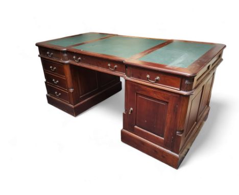 An early 20th century mahogany twin pedestal partners desk, three panel leather writing surface with six drawers, each pedest