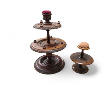 A 19th century&nbsp;mahogany seamstress's circular two-tier cotton bobbin stand, pin cushion finial, 27cm high;&nbsp; &nbsp;a