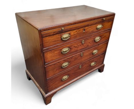 A George III mahogany caddy top bachelors chest, crossbanded top with moulded edge above a slide with baize, four long gradua