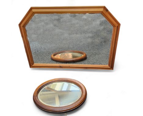A hexagonal pine wall/overmantel mirror 103cm wide, 73cm high; an oak oval wall mirror, bevelled edge mirror panel 54cm acros