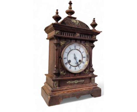 A German Junghans oak mantel clock, Arabic numerals, twin winding holes, eight day movement striking&nbsp; on a gong, the cas