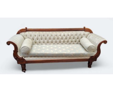 A Victorian mahogany scroll end sofa, upholstered in cream, turned legs. caster feet 