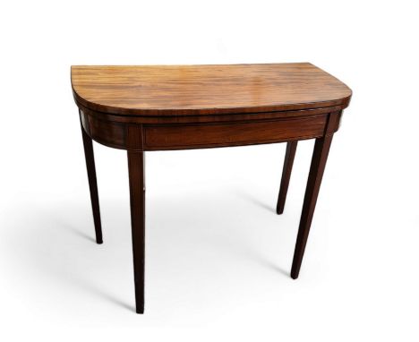 A 19th century mahogany demi-lune card table, folding top enclosing green baize-lined playing surface, boxwood stringing, tap