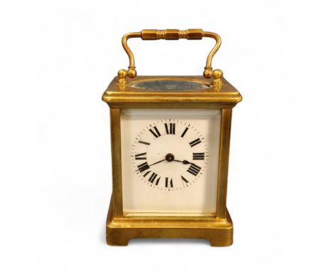 A 20th century brass carriage clock, Roman numerals, swing handle, 10cm high 