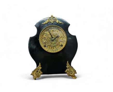 A French cartouche shaped ebonised and gilt mantel clock, 12cm diam with Arabic numerals, two winding holes, eight day moveme